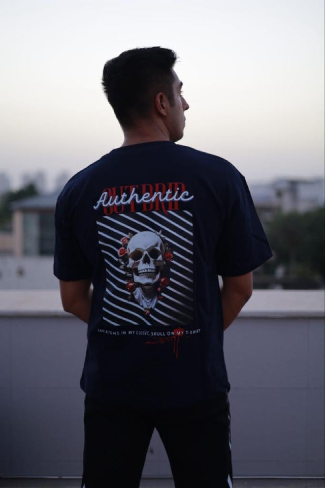 Back view of male model in EMBOSSED LOGO T-shirt – soft pink oversized fit with drop shoulders and minimalist streetwear vibe