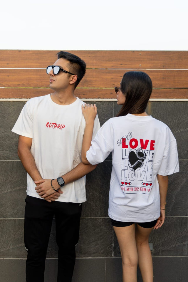 Male and female models wearing matching white Love T-shirts by Outdrip, highlighting the screen-printed quote.