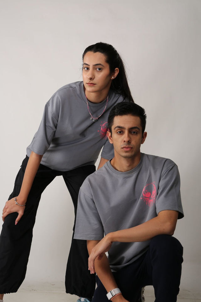 SKULLS IN THE GRAVE T-shirt on male and female models – unisex grey t-shirt by Outdrip with screen and puff print
