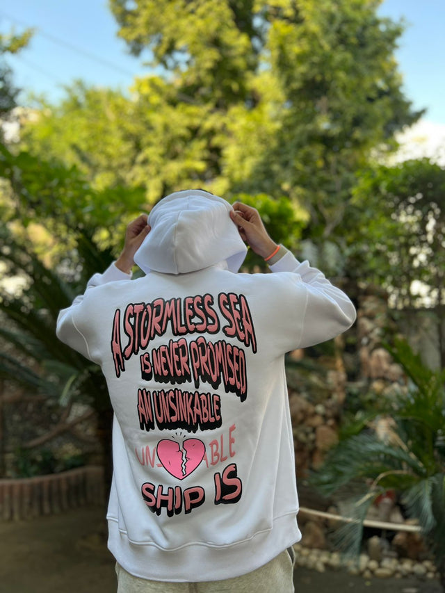 back photo of model wearing unisex unsinkable ship hoodie from outdrip