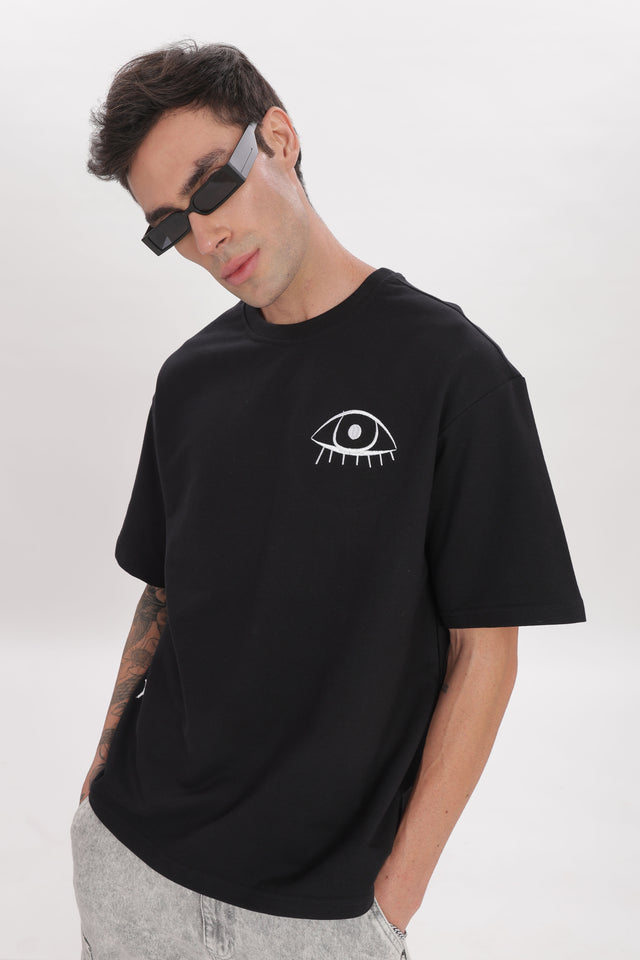 model wearing unisex cosmic watcher tee from outdrip 