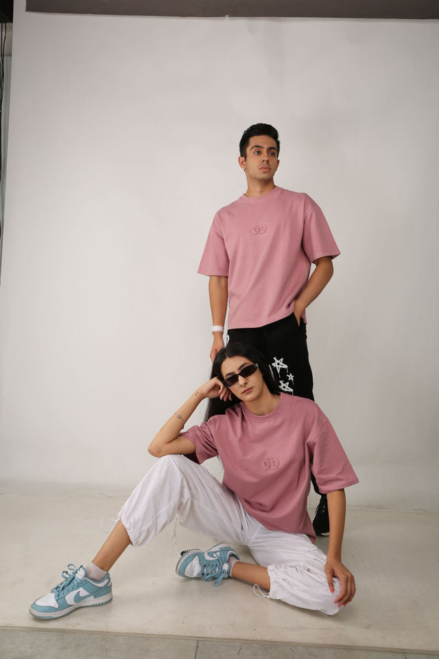 EMBOSSED LOGO T-shirt on male and female models – unisex pink tee by Outdrip with 3D embossed front logo and streetwear styling
