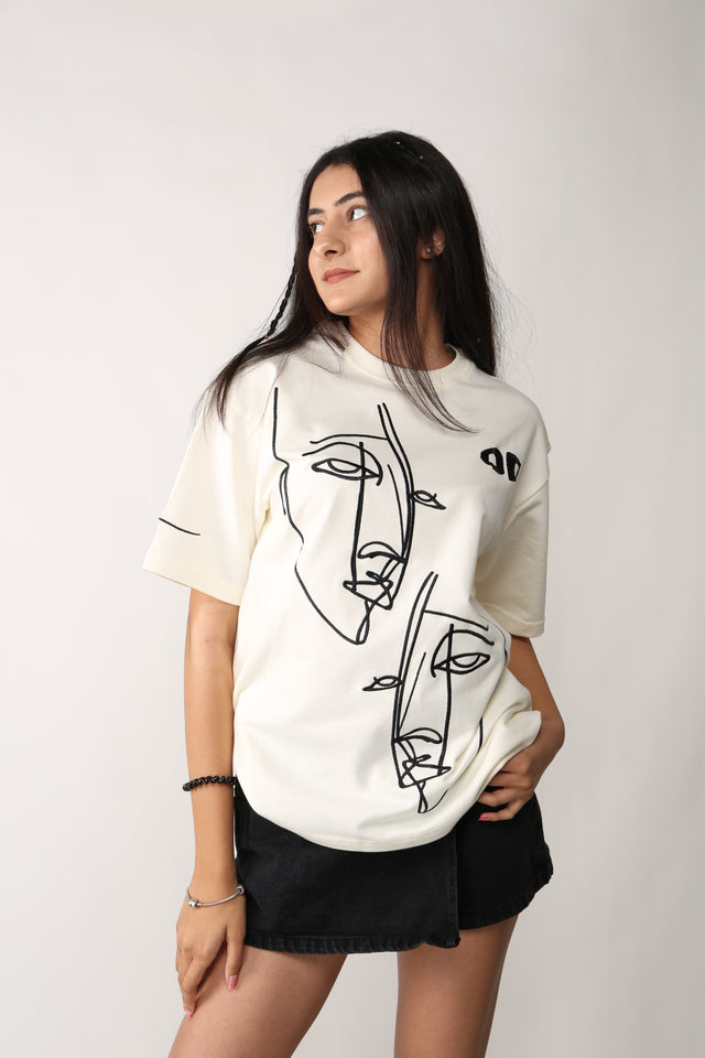Female model in FRAGMENTED FACES T-shirt – edgy oversized streetwear with abstract visual