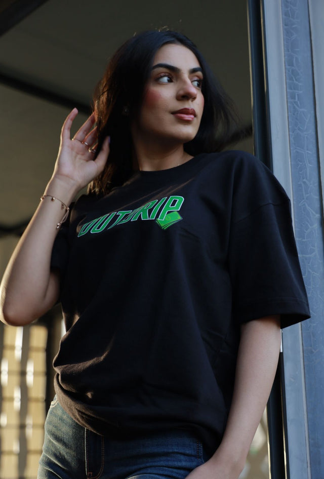  Female model in black Hustle Tee by Outdrip, styled for unisex streetwear fashion.
