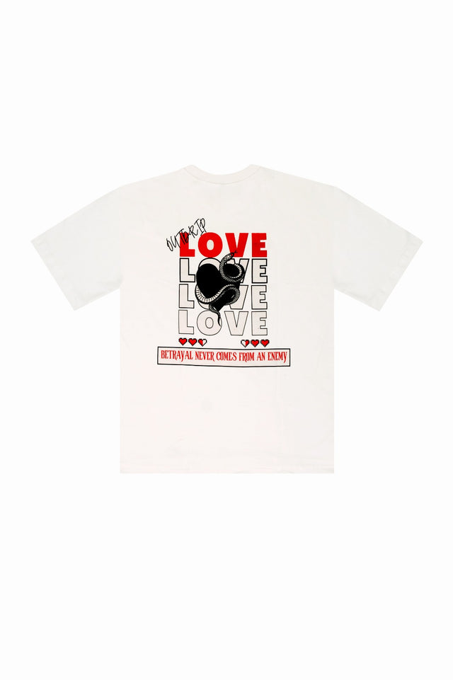 Back mockup of the white Love tee by Outdrip with the quote “Betrayal never comes from an enemy” in bold screen print.
