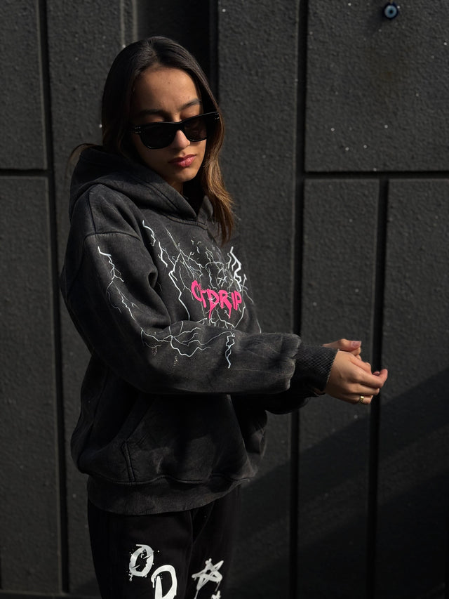Female model styled in OD THUNDER HOODIE – relaxed fit hoodie with front DTF design and acid wash finish